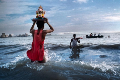 , Steve McCurry, Devotee carries statue of Lord Ganesh into the waters of the Arabian Sea during the immersion ritual off Chowpatty beach, Mumbai, India, 1993, ultrachrome print, 40 x 60 inches/101.6 x 152.4 cm; &copy; Steve McCurry